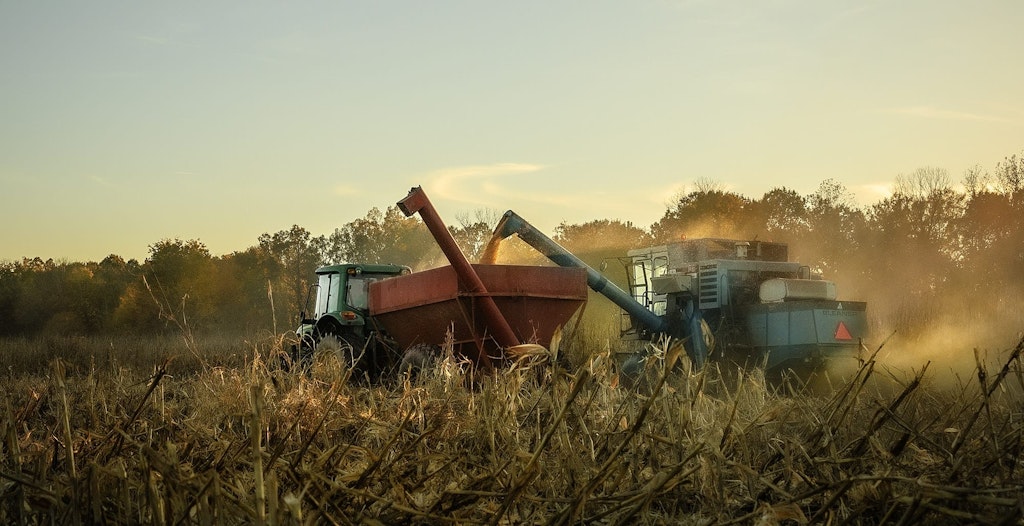farm equipment in a field harvesting corn